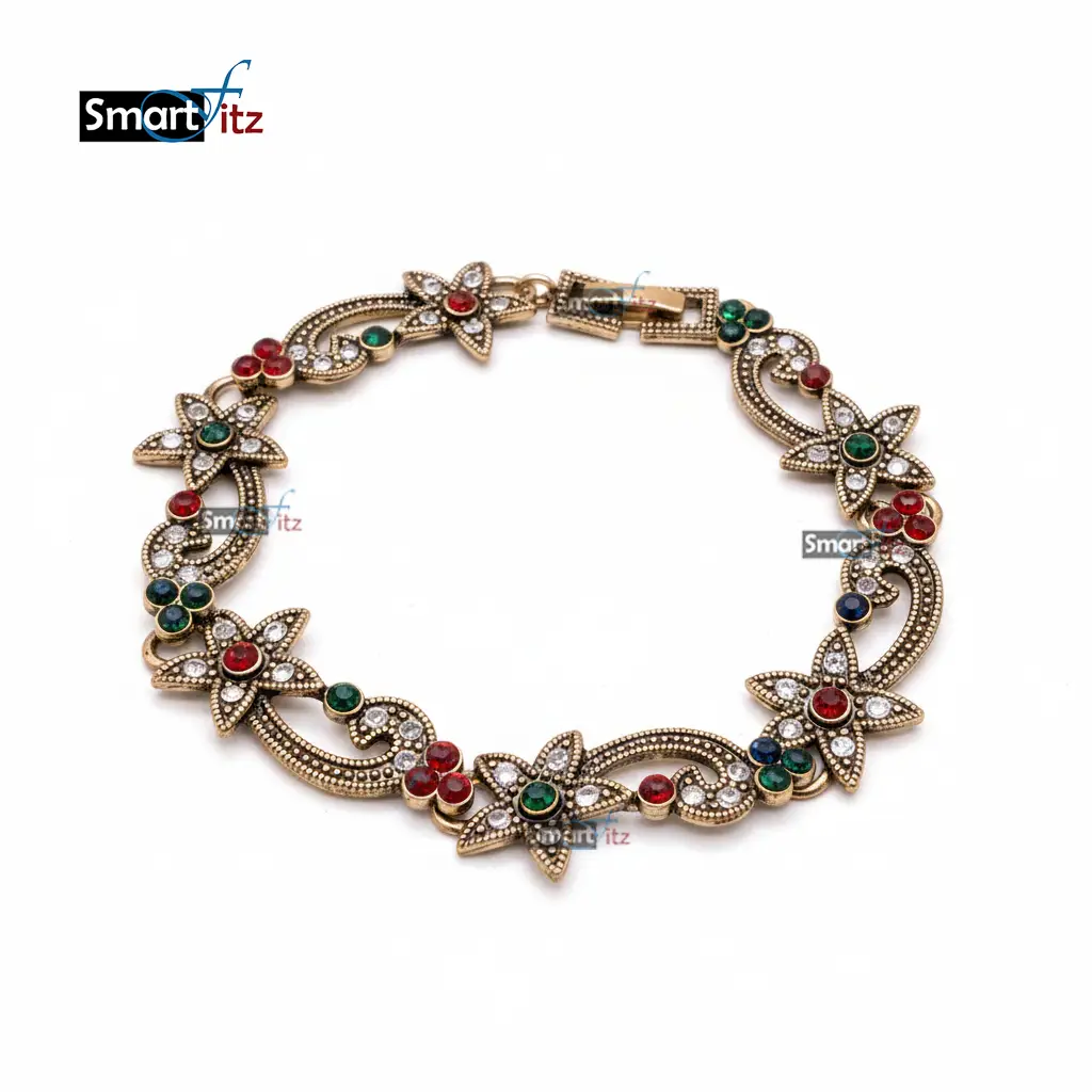 Antique gold floral bracelet with red, green, and blue gemstones on a white background